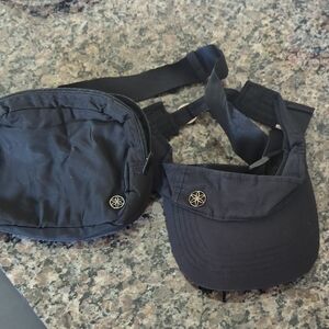 GAIAM Black Nylon Crossbody Bag/Fanny Pack And Black Visor With Adjustable Back.